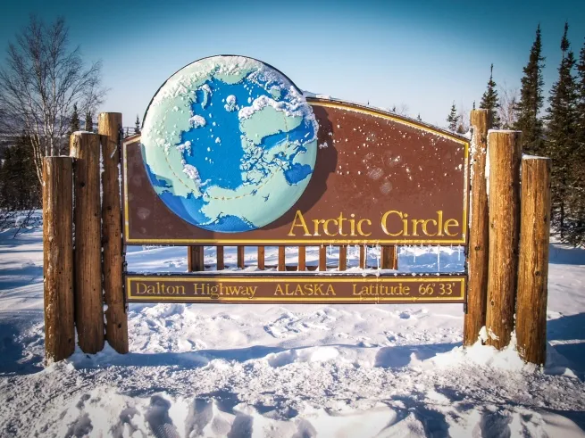 Sign seen during an Arctic tour displaying the boundaries of the Arctic Circle